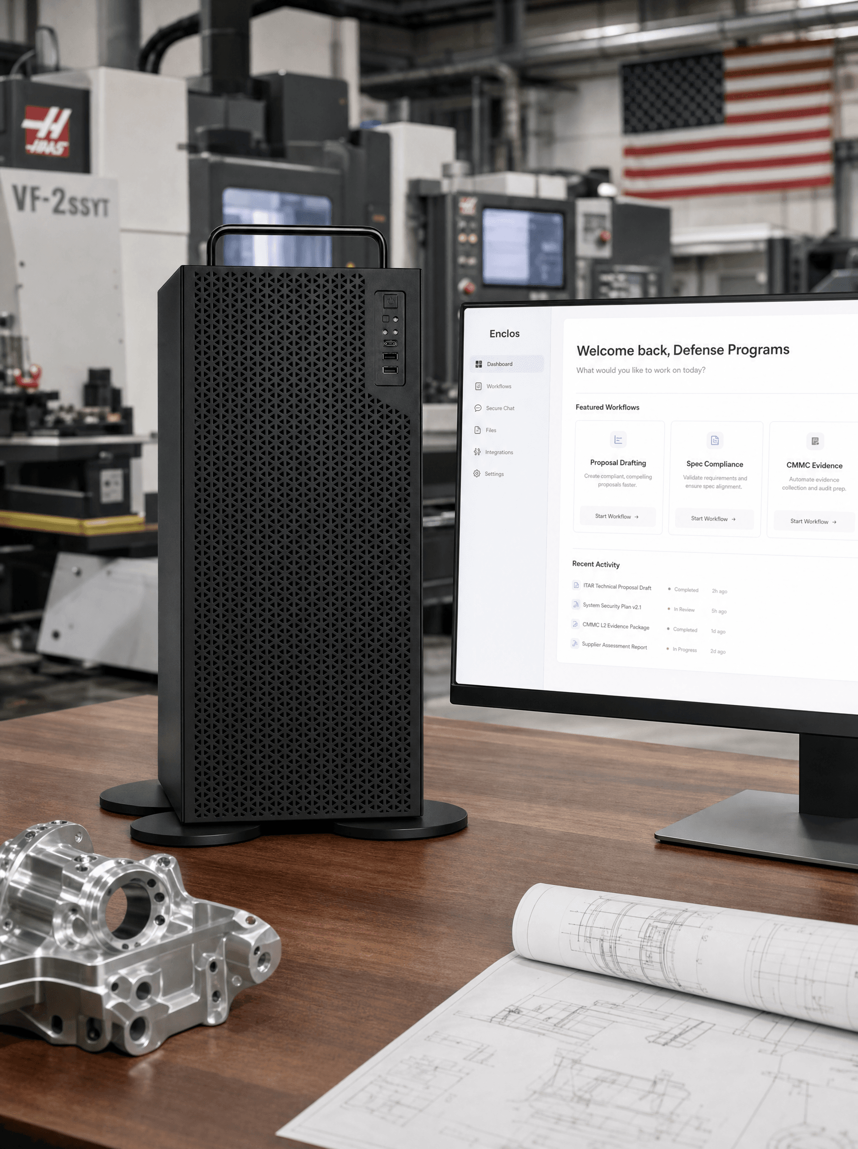 The Enclos system in a defense manufacturing facility: a desktop monitor running the private workspace beside the Enclos appliance